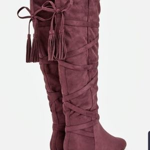 Knee High burgundy boots.